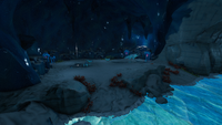 A large cave housing a pack of Snow Stalker Babies and a singular Snow Stalker