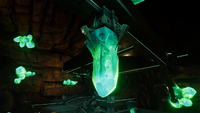 A claw-like mechanism securing an emerald in place