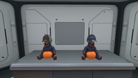 The two Cap variations being worn by Arcade Gorge Toys on a Counter.