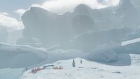 A Pengwing with it's young roaming through the frigid landscape
